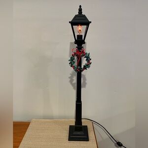 Byers Choice Carolers lamp post. Decorated with a Christmas wreath.